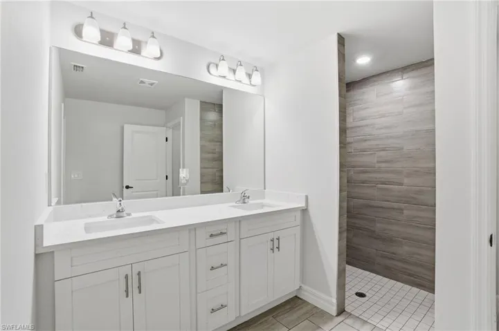 Full bath with double vanity and walk in shower
