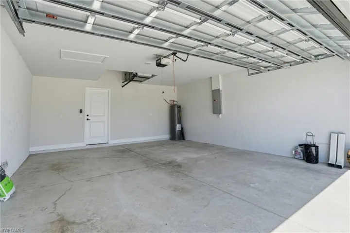 Garage with water heater and electric panel