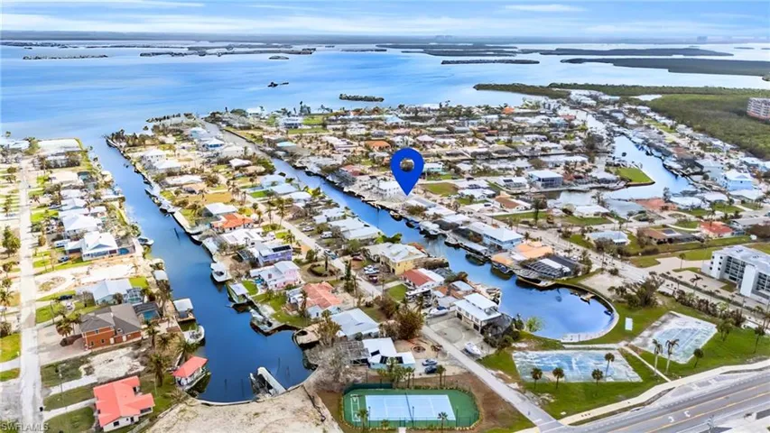 Birds eye view of property with a water view