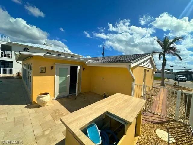 Rear view of house with a patio area and bar structure