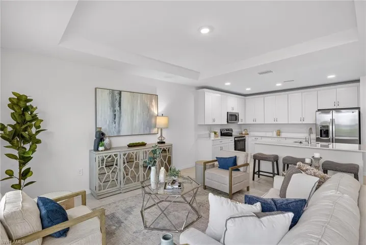Living room with a raised ceiling and recessed lighting