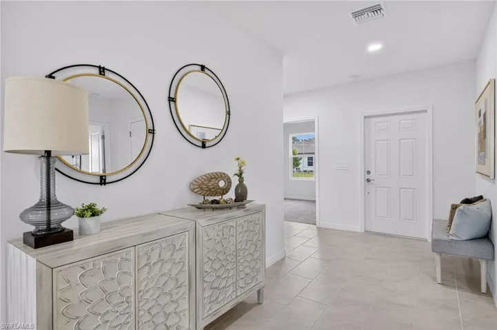 Foyer featuring light tile patterned floors and recessed lighting