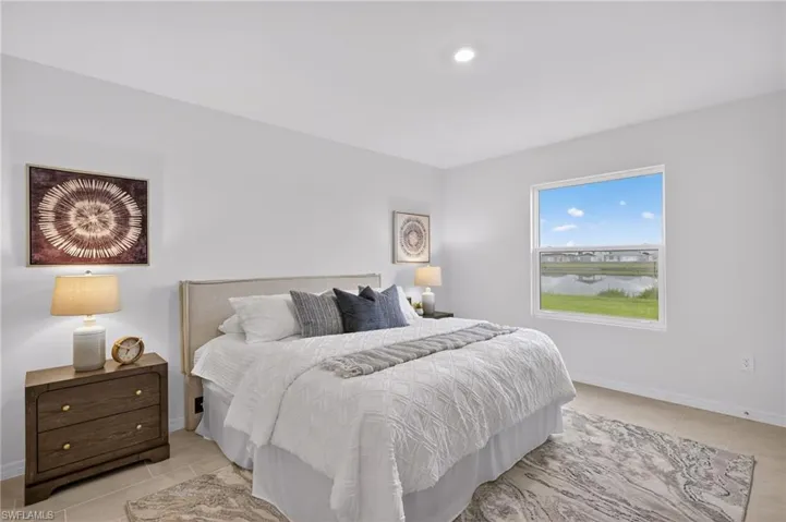 Bedroom with light tile patterned flooring and baseboards