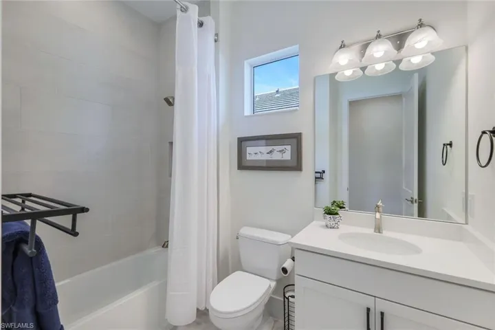 Full bathroom with vanity, toilet, and shower / bath combo