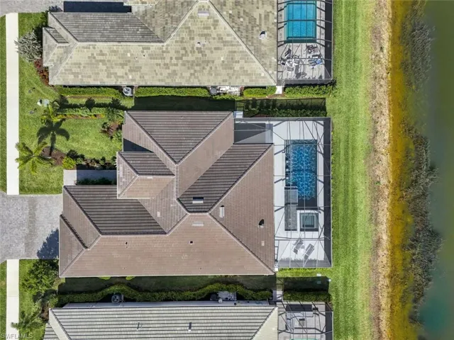 Birds eye view of property with a water view