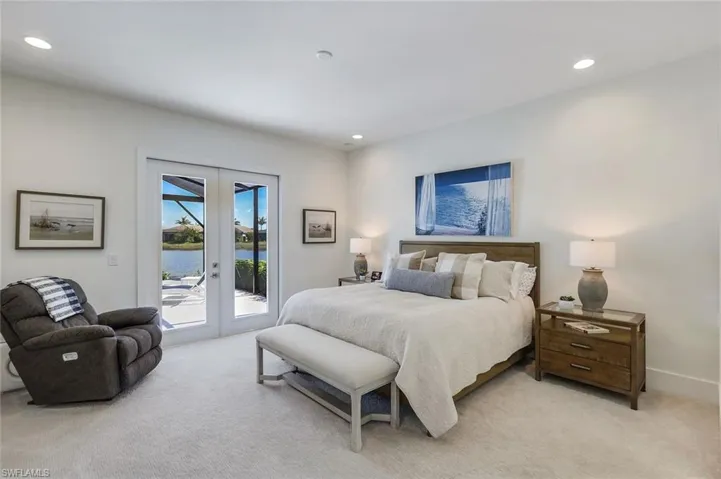 Carpeted bedroom featuring access to exterior and french doors