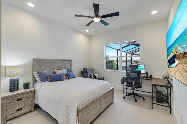 Bedroom featuring ceiling fan and light colored carpet