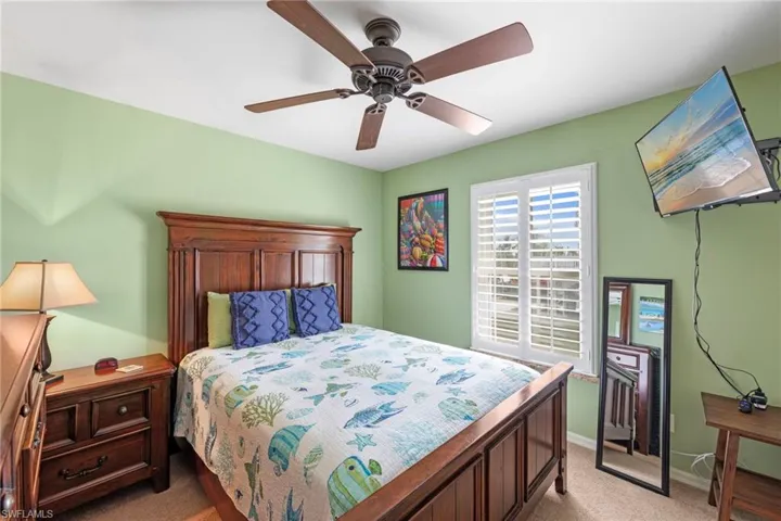 Bedroom featuring light carpet and a ceiling fan