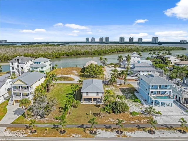 Aerial perspective of suburban area with skyline and a nearby body of water