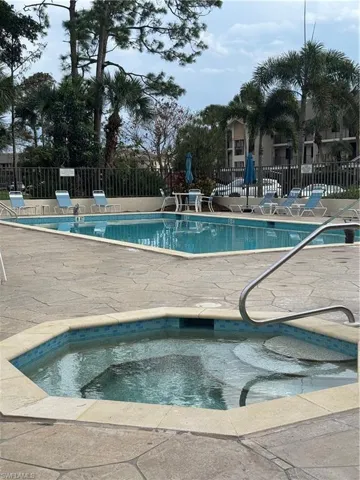 Community pool with a patio and a community hot tub