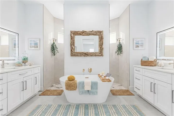 Contemporary bathroom featuring a freestanding soaking tub, dual walk-in showers with glass enclosures, and twin vanity cabinets with integrated sinks and illuminated mirrors