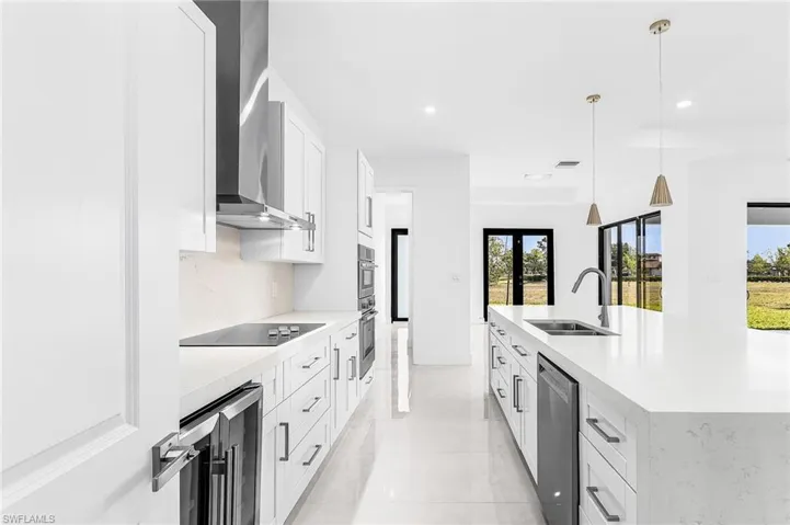 Contemporary kitchen featuring an expansive island with an undermount sink and gooseneck faucet