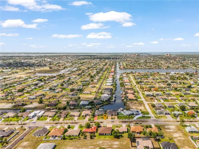 Aerial perspective showcasing a residential community with numerous single-story homes