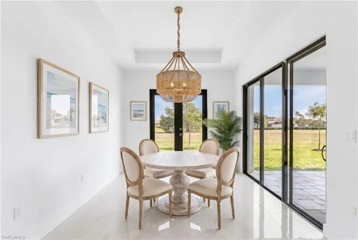 Dining space featuring a coffered ceiling and a natural fiber chandelier