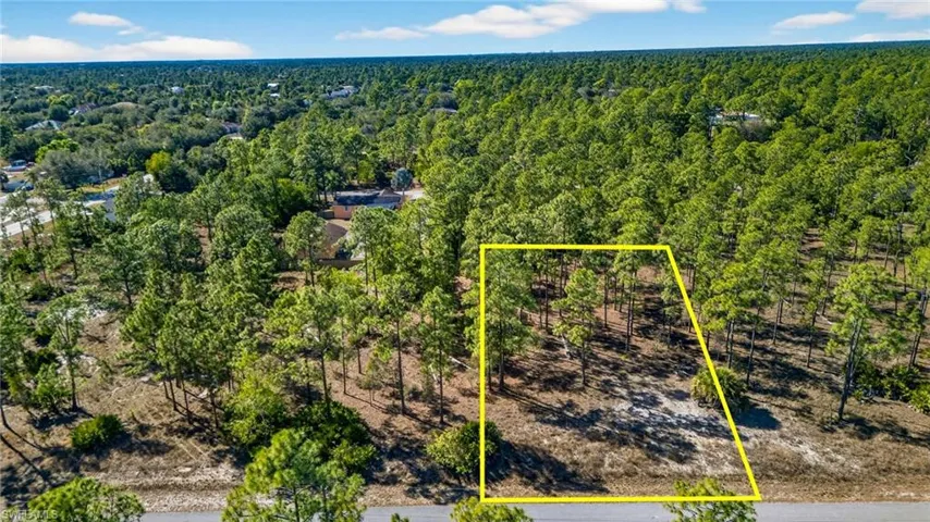 Aerial view of property's location with property boundaries highlighted and a forest