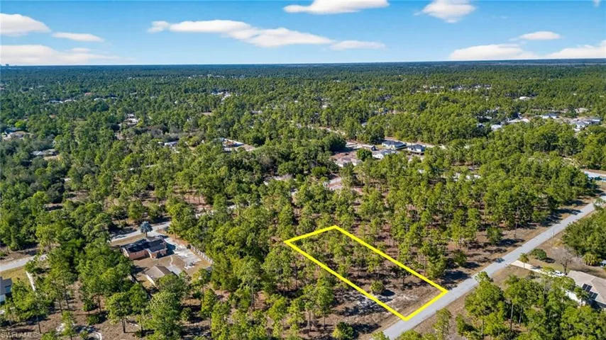 Aerial overview of property's location featuring a forest and property parcel outlined