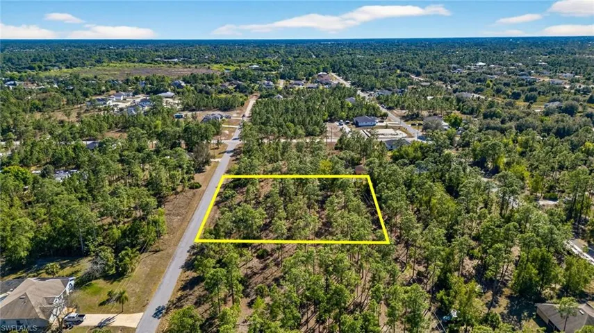 Aerial overview of property's location featuring a forest and property parcel outlined