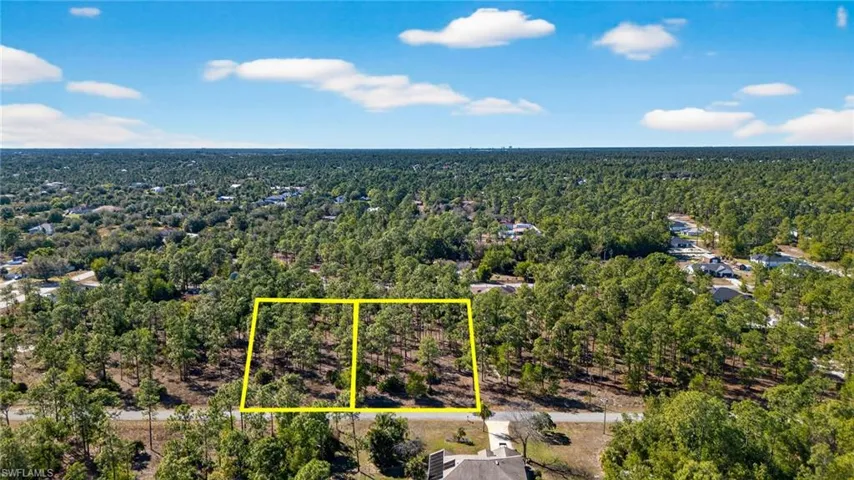 Aerial view of property's location featuring property boundaries highlighted and a forest