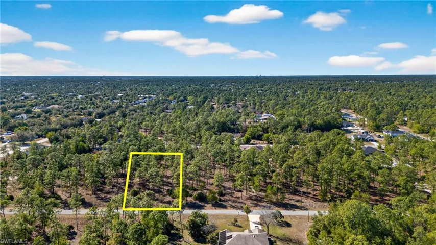 View of property location featuring property parcel outlined and a heavily wooded area