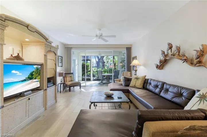 Living room with ceiling fan and light wood-style floors
