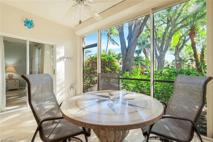 Sunroom / solarium featuring outdoor dining area and ceiling fan