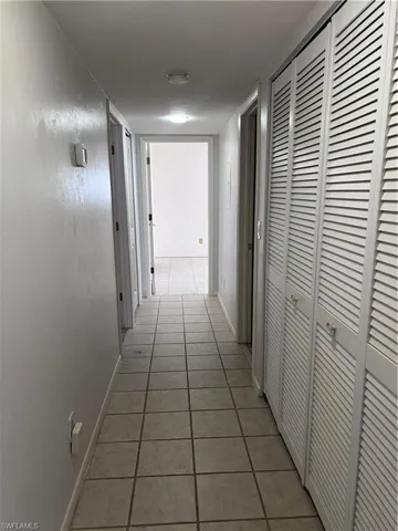 Hallway with tile patterned flooring