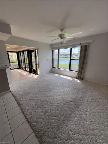 Carpeted spare room with ceiling fan