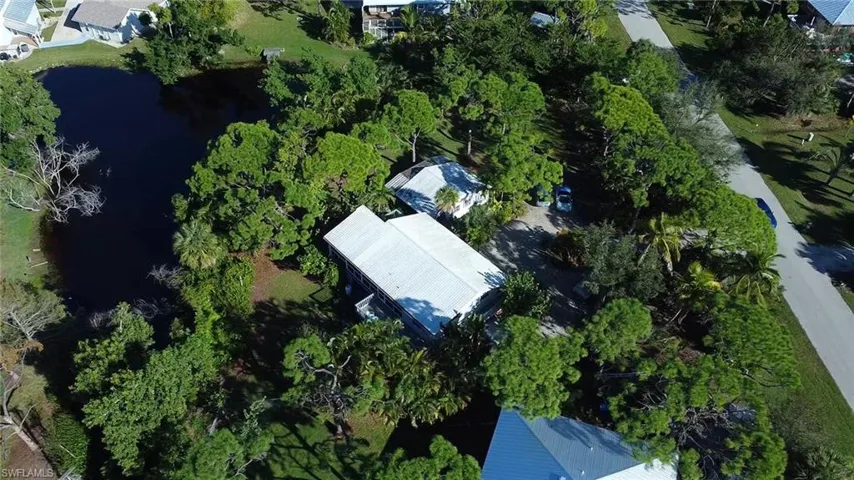 Feel secluded in trees! Backyard full of grass and shared pond on .82 acres