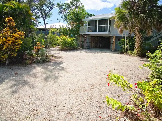 Doors open to the garage/workshop. Balcony above leads to upstairs 2nd bedroom