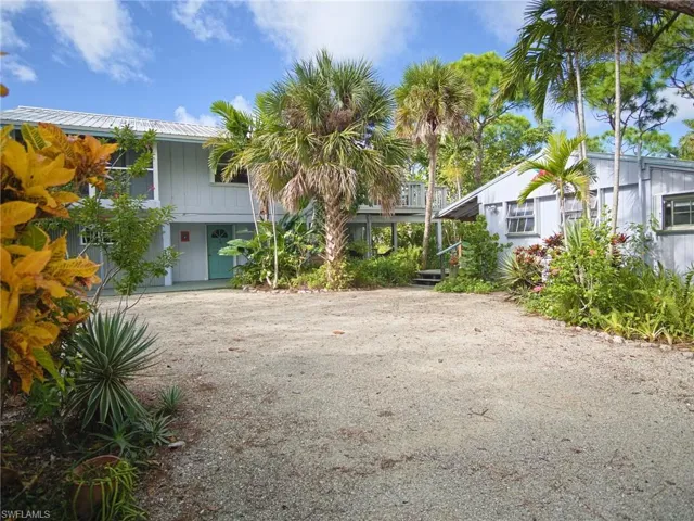 Circular driveway leads to both homes, the garage, and parking off to the side