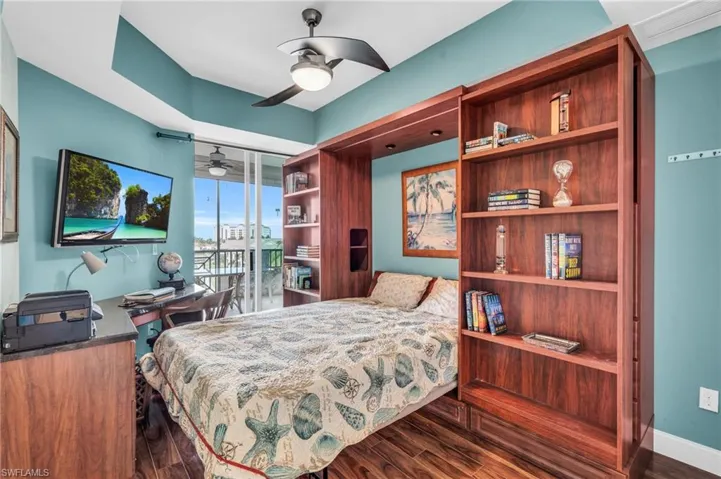 Bedroom with ceiling fan and dark hardwood / wood-style flooring
