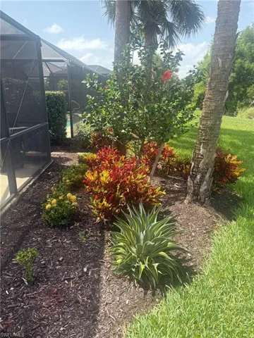 View of yard featuring a lanai and a sunroom