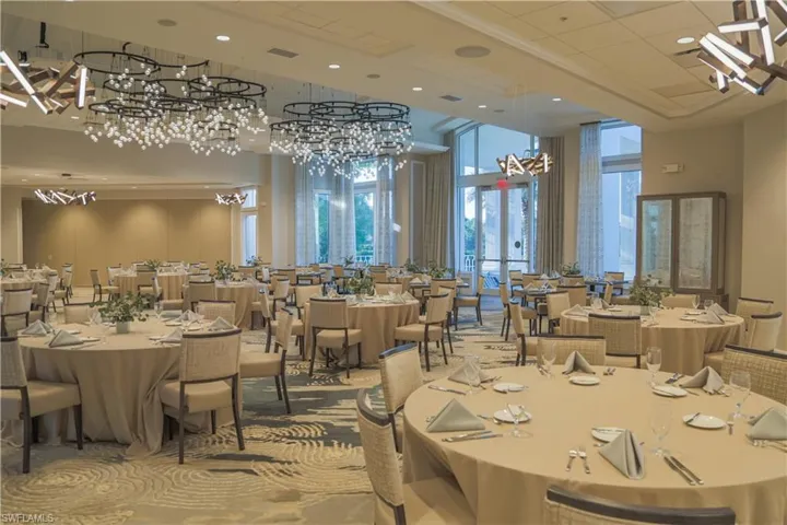 Dining room featuring a chandelier, a towering ceiling, recessed lighting, and carpet