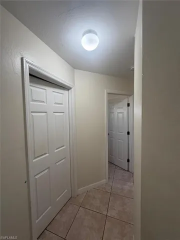 Hall with light tile patterned floors
