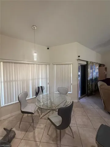 Dining area featuring light tile patterned flooring