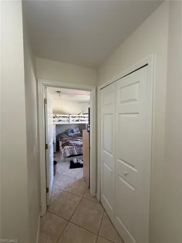 Hallway with light tile patterned floors