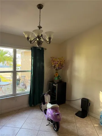 Tiled dining area with an inviting chandelier