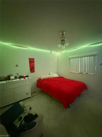 Tiled bedroom with ceiling fan