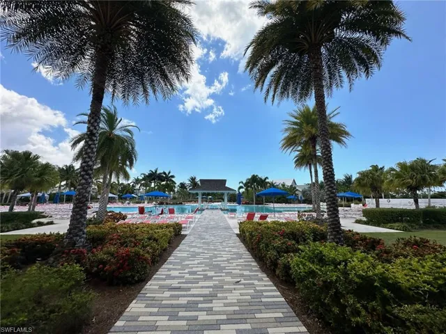 View of home's community with a pool and a patio