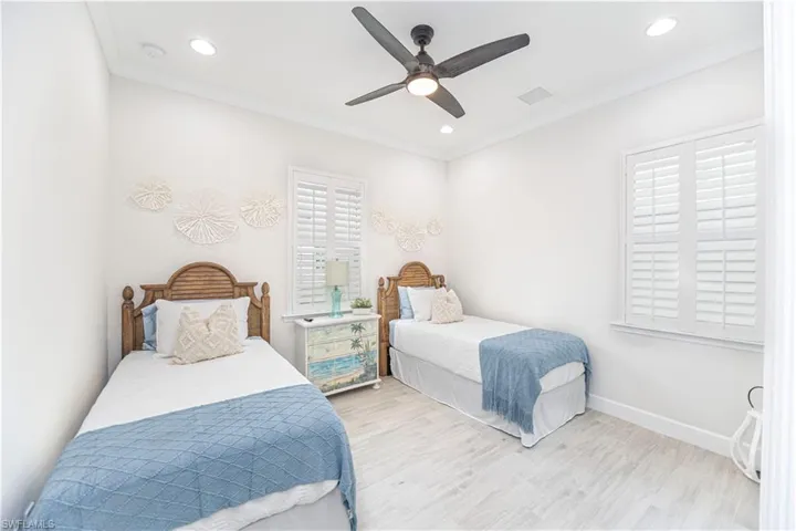 Bedroom featuring crown molding, ceiling fan, and light hardwood / wood-style flooring