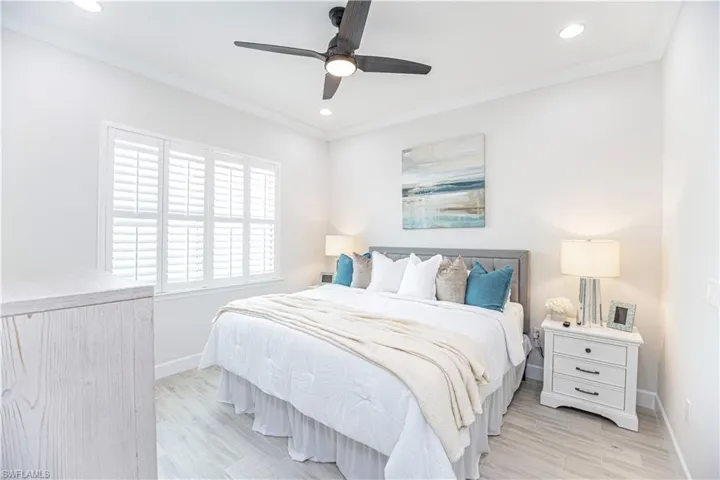 Bedroom featuring crown molding, ceiling fan, and light wood-type flooring