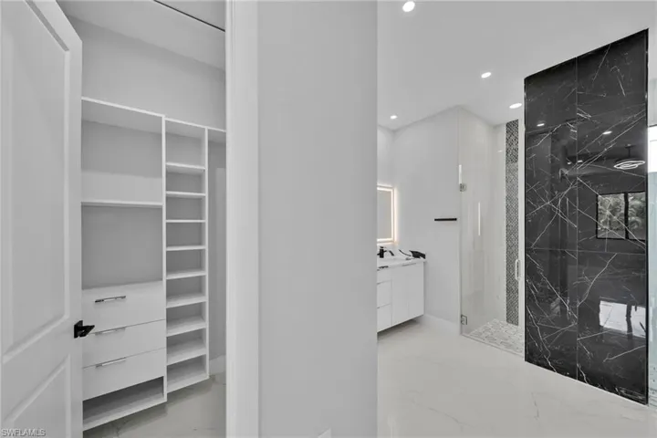 Bathroom with vanity and a tile shower