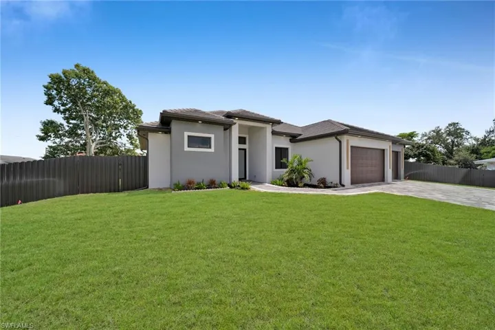 Prairie-style home with a front lawn and a garage