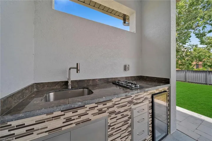 View of patio with wine cooler and sink