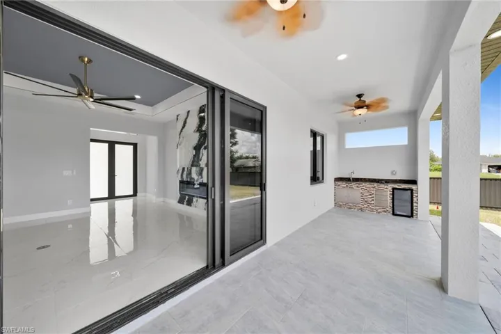 View of patio / terrace with exterior kitchen, beverage cooler, and ceiling fan