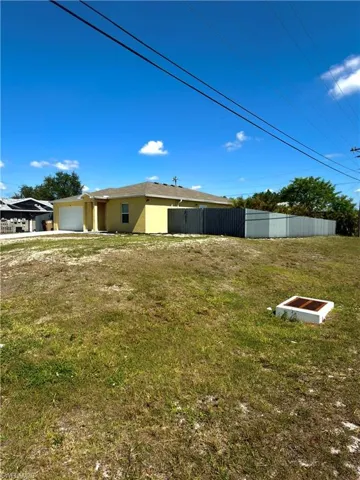 Single-story residence featuring a neutral-toned exterior, an attached garage, and a fenced perimeter