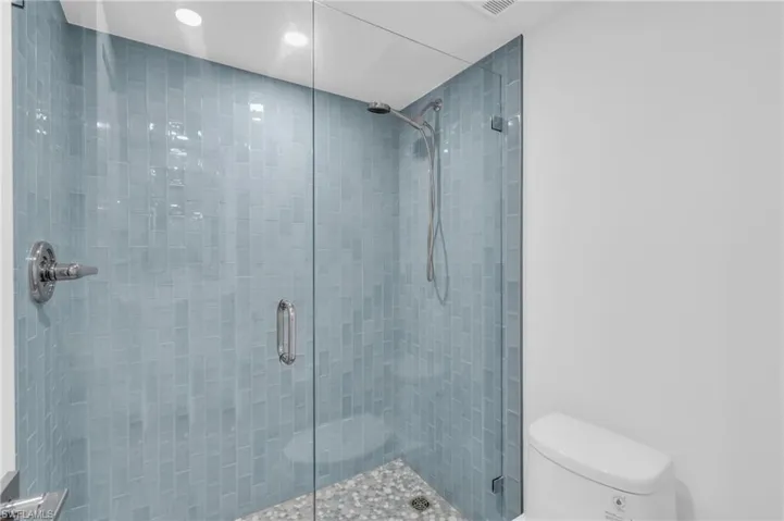 Full bath with a shower stall and recessed lighting