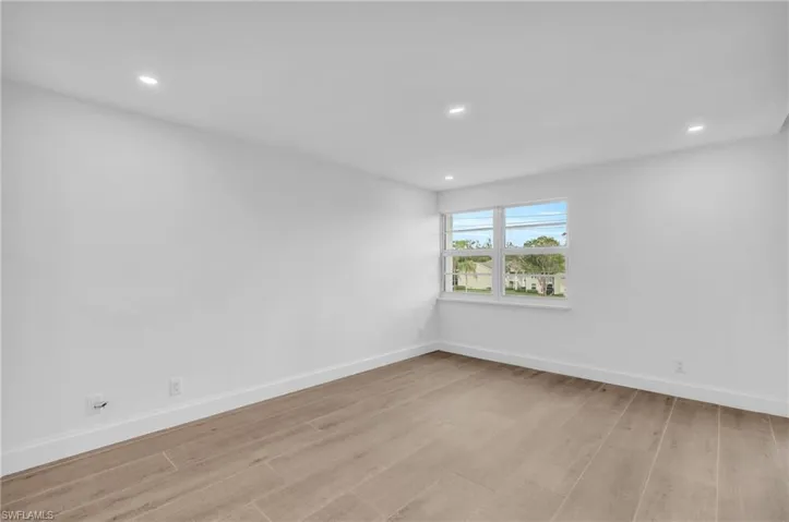 Unfurnished room with light wood-style floors and recessed lighting