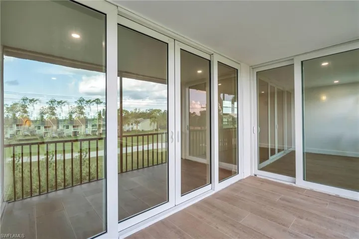 Entryway featuring a residential view, wood finished floors, recessed lighting, and floor to ceiling windows