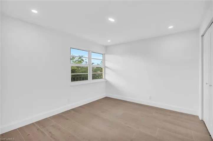Spare room with recessed lighting and light wood-style flooring
